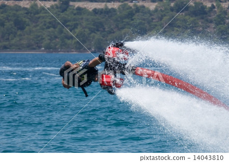 Flyboarder in black shorts and lifejacket horizontal 14043810
