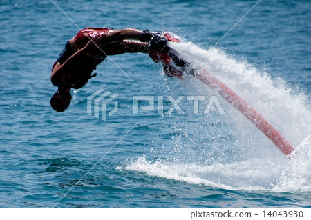Flyboarder in red shorts diving into sea 14043930
