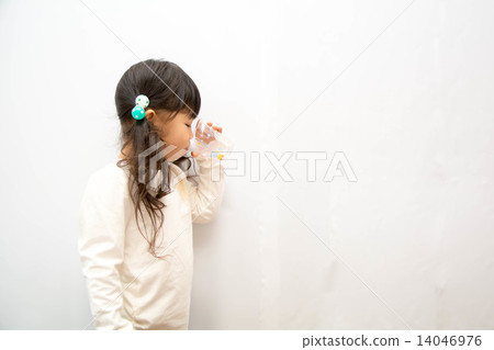 A girl drinking water with a cup 14046976