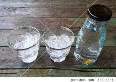Fresh water in glass on wooden table. 14048871