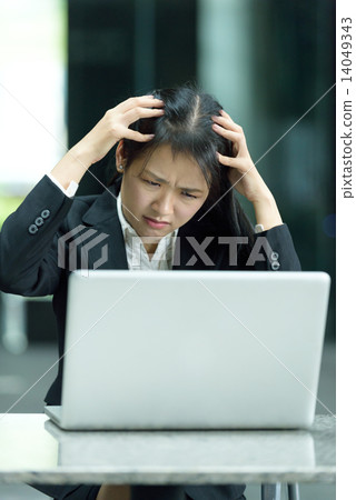 Chinese businesswoman having a bad day at work Chinese businesswoman having a bad day at work 14049343