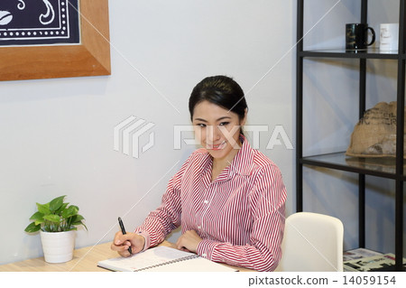 Woman business executive in-door cafe table  14059154
