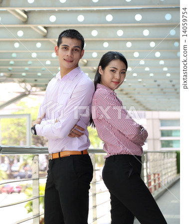 Man woman business executive outdoor pose back to back Man woman business executive outdoor pose back to back 14059754