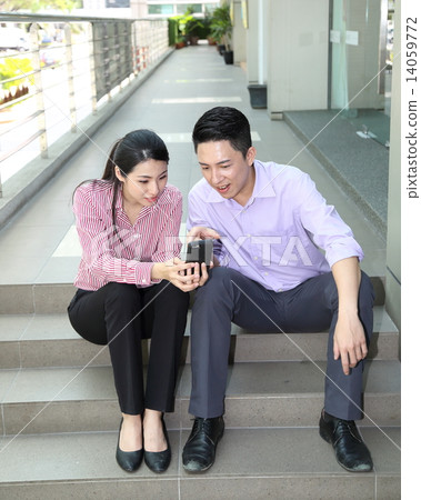 Man woman business executive  outdoor pose relax sit on stair phone 14059772