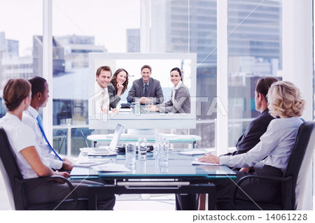 Composite image of group of business people looking at a screen Composite image of group of business people looking at a screen 14061228