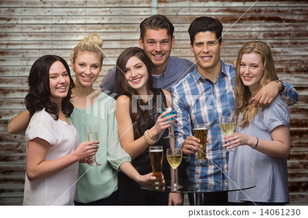 Composite image of friends with drinks Composite image of friends with drinks 14061230
