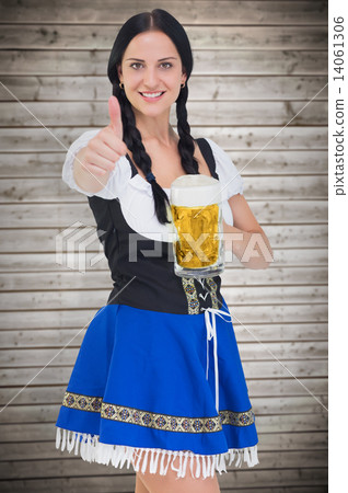 Composite image of pretty oktoberfest girl holding beer tankard 14061306