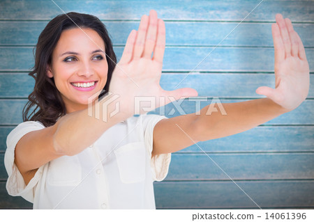Composite image of pretty brunette holding up hands Composite image of pretty brunette holding up hands 14061396