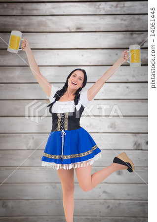 Composite image of pretty oktoberfest girl holding beer tankards 14061448