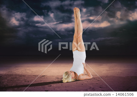 Composite image of fit young woman doing the shoulder stand pose 14061506