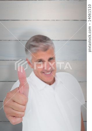 Composite image of casual man showing thumbs up at camera 14061510