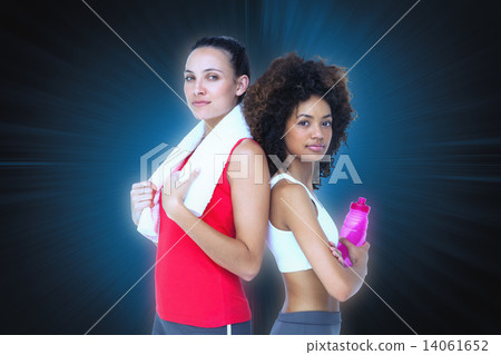 Composite image of fit women standing with waterbottle and towel 14061652