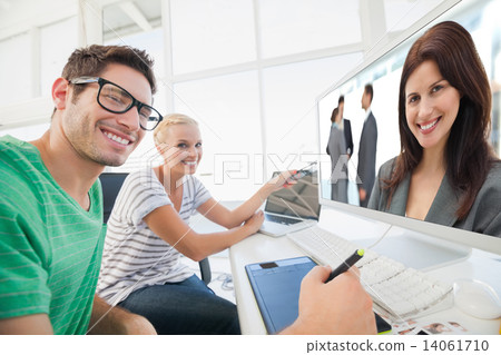 Composite image of happy businesswoman posing while her team dis 14061710