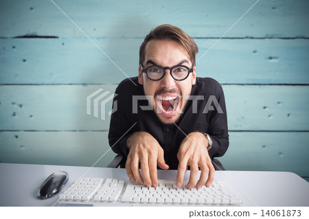 Composite image of excited businessman typing on keyboard 14061873