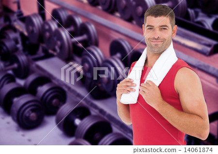Composite image of fit man smiling at camera 14061874