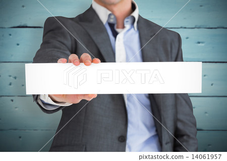 Composite image of businessman in grey suit showing card 14061957