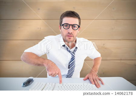 Composite image of businessman working at his desk 14062178