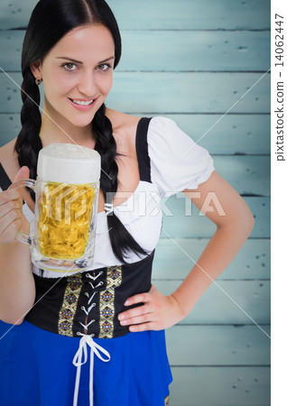 Composite image of pretty oktoberfest girl holding beer tankard Composite image of pretty oktoberfest girl holding beer tankard 14062447