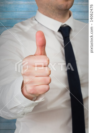 Composite image of businessman giving thumbs up to camera 14062476