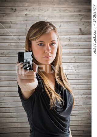 Composite image of femme fatale pointing gun at camera 14062477