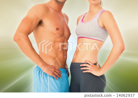 Composite image of mid section of a fit young couple Composite image of mid section of a fit young couple 14062937