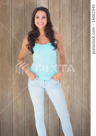Composite image of casual brunette smiling at camera Composite image of casual brunette smiling at camera 14062940