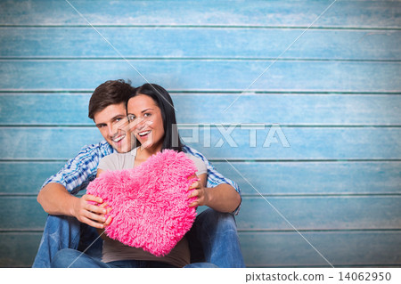 Composite image of young couple sitting on floor smiling Composite image of young couple sitting on floor smiling 14062950