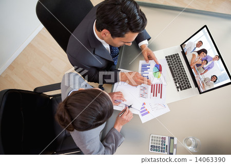 Composite image of international business associates in a meetin Composite image of international business associates in a meetin 14063390