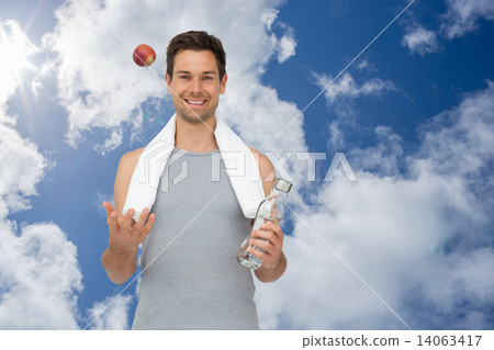 Composite image of smiling fit young man with apple and water bo 14063417