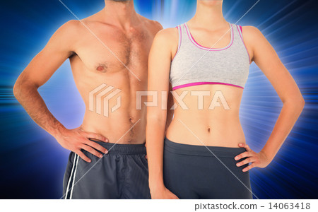 Composite image of mid section of a fit young couple 14063418
