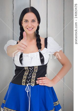 Composite image of pretty oktoberfest girl smiling at camera Composite image of pretty oktoberfest girl smiling at camera 14063476