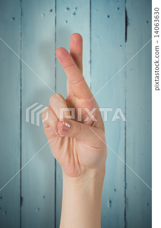 Composite image of hand with fingers crossed Composite image of hand with fingers crossed 14063630