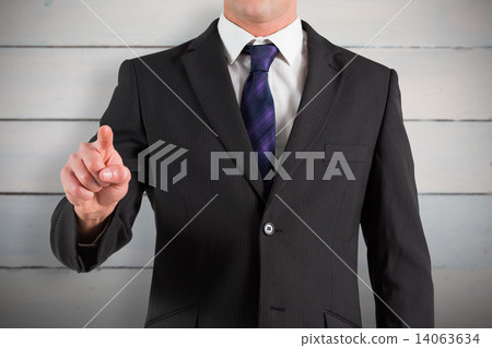 Composite image of businessman in suit pointing finger Composite image of businessman in suit pointing finger 14063634