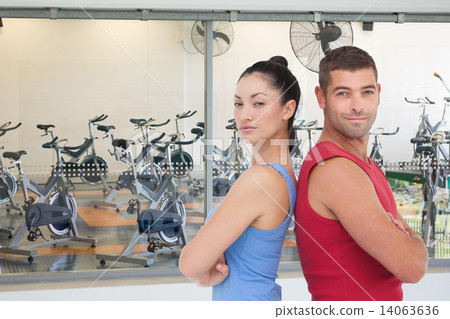 Composite image of fit man and woman smiling at camera together Composite image of fit man and woman smiling at camera together 14063636