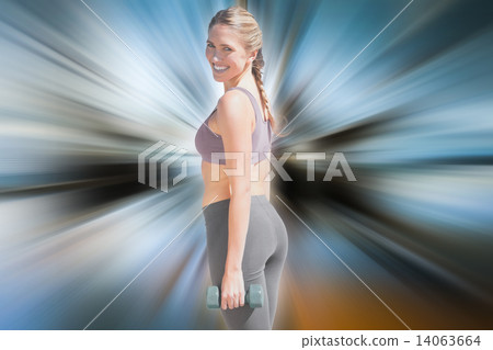 Composite image of fit woman working out with dumbbells on the b 14063664