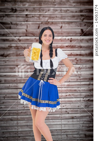 Composite image of pretty oktoberfest girl holding beer tankard Composite image of pretty oktoberfest girl holding beer tankard 14063774