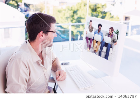 Composite image of casual businessman using computer Composite image of casual businessman using computer 14063787