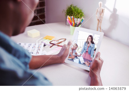 Composite image of photo editor using tablet pc 14063879