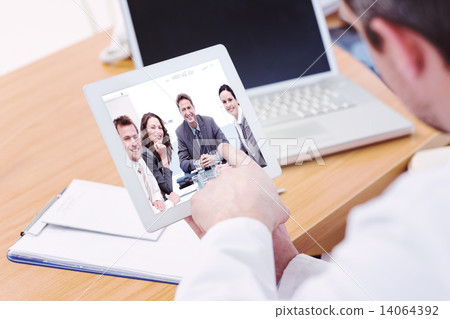 Composite image of doctors using laptop and digital tablet in me 14064392