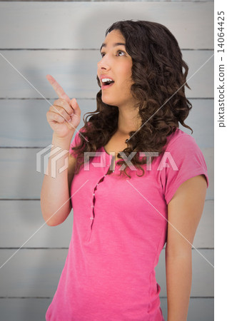 Composite image of surprised brown haired woman pointing out Composite image of surprised brown haired woman pointing out 14064425