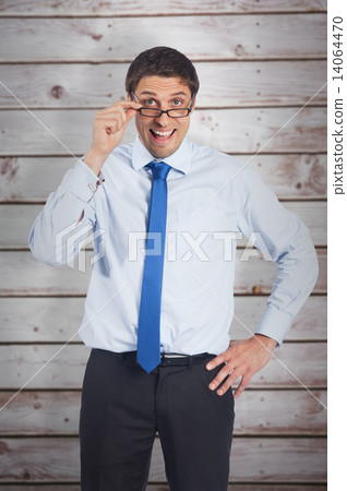 Composite image of thinking businessman tilting glasses Composite image of thinking businessman tilting glasses 14064470