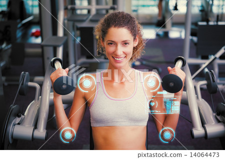 Composite image of fit smiling woman using the weights machine f Composite image of fit smiling woman using the weights machine f 14064473