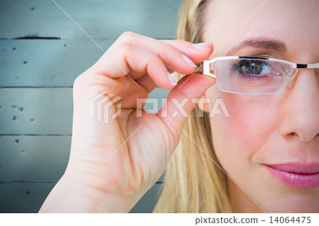 Composite image of close up of pretty blonde with reading glasse 14064475