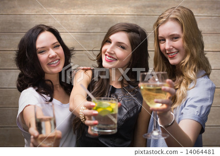 Composite image of friends with drinks Composite image of friends with drinks 14064481