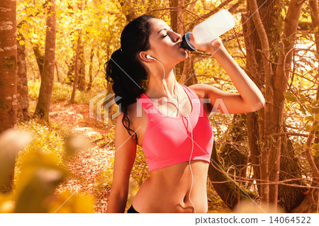 Composite image of beautiful healthy woman drinking water Composite image of beautiful healthy woman drinking water 14064522
