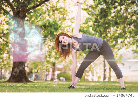 Composite image of pretty athletic redhead stretching in park Composite image of pretty athletic redhead stretching in park 14064745