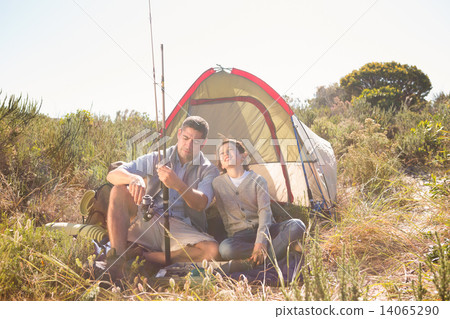 Father and son beside their tent in the countryside 14065290