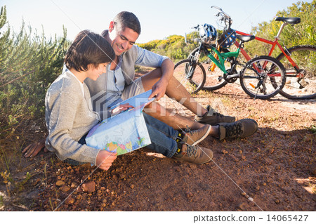 Father and son on a bike ride Father and son on a bike ride 14065427