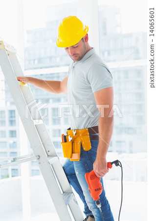 Manual worker with drill machine climbing ladder Manual worker with drill machine climbing ladder 14065601