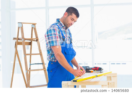 Handyman working at workbench in office 14065680